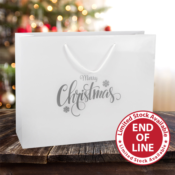 Large Merry Christmas paper carrier bags from stock at MIDPAC Packaging. White gloss laminated paper carrier bags with a silver Merry Christmas design printed on 1 side of the bags